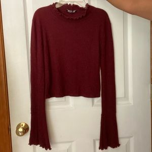 Ruffles turtle neck long sleeve shirt.